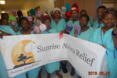 Patients at Queen Mamohato Memorial hospital hold the Sunrise Africa banner