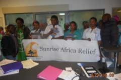 Staff and patients with charity banner